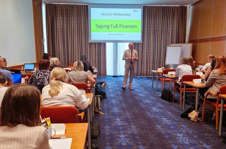 Teilnehmerinnen und Teilnehmer der Tagung des Bereichs Finanzen sitzen in großem Tagungsraum des Hotels.